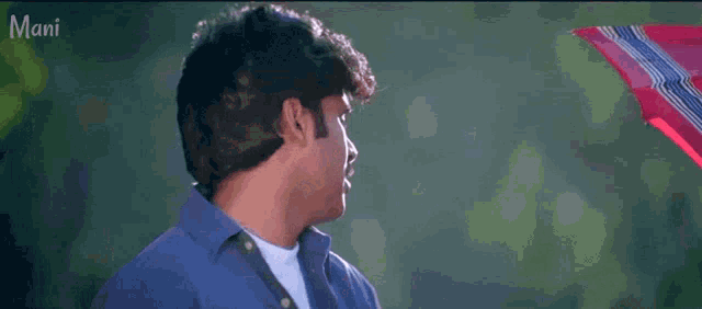 a man with a mustache is wearing a blue shirt and a white shirt
