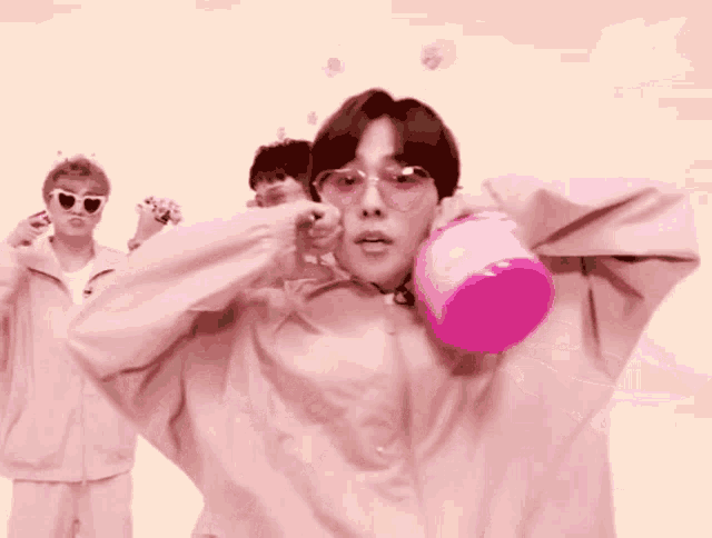 a man in a pink jacket holding a pink bucket