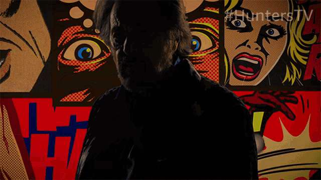 a man with a beard stands in front of a collage of comic strips with the hashtag #hunterstv on the bottom