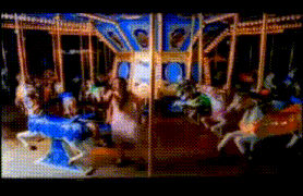 a merry go round with people riding on it
