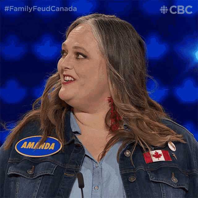 a woman wearing a denim jacket has a name tag that says amanda