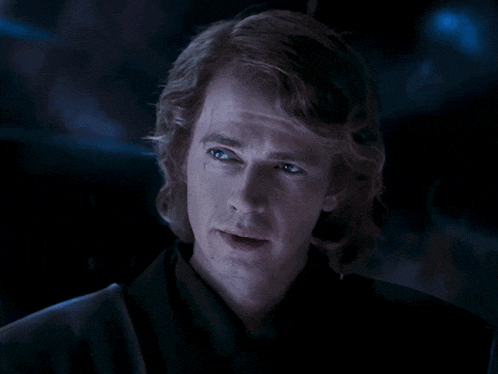a close up of a man 's face with long hair