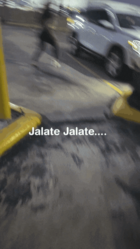a blurry picture of a parking lot with jalate jalate written on the bottom