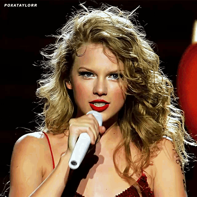 a close up of a woman singing into a microphone with the words poxataylorr written above her