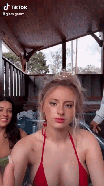 a woman in a red bikini is sitting in a hot tub with other women .