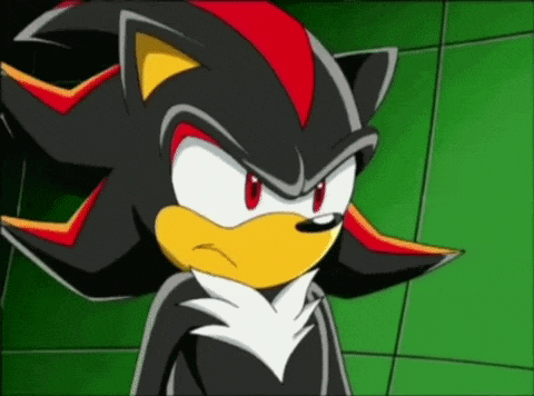shadow the hedgehog from sonic the hedgehog is looking at the camera with an angry look on his face .