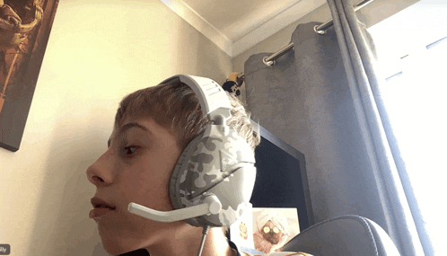 a boy wearing a headset with a microphone and a sticker that says ' reply ' on it