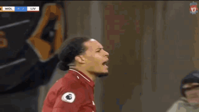 a soccer player in a red shirt with the number 1 on it