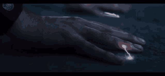 a person 's hand with a lightning bolt on it .