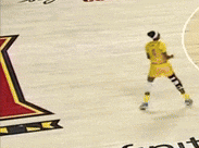 a man in yellow shorts stands on a ice rink
