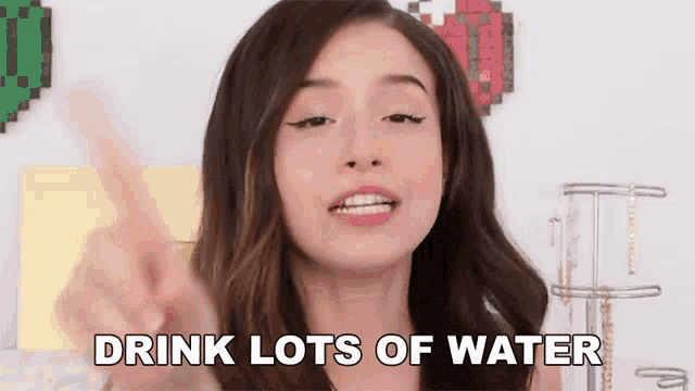 a woman is making a funny face and saying drink lots of water