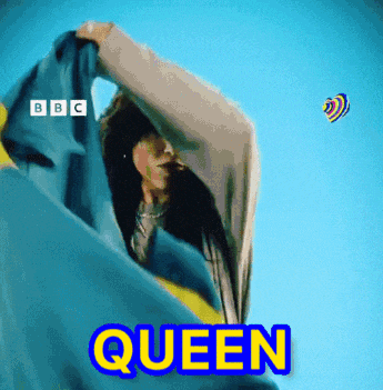 a woman is wrapped in a blue and yellow blanket and the word queen is written in yellow