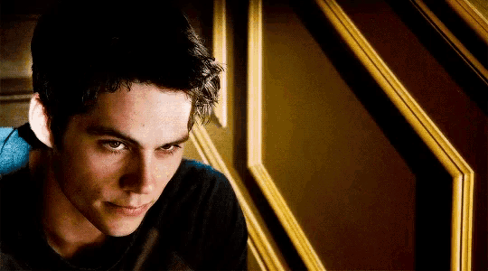 a close up of a man 's face in front of a staircase