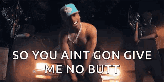 a man is kneeling down in front of a car with the words `` so you ain t gon give me no butt ''