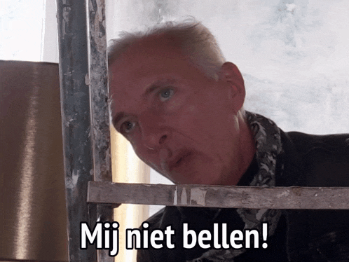 a man with a scarf around his neck is looking out a window with the words mij niet bellen below him