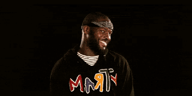 a man wearing a headband and a shirt that says ' mar ' on it