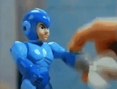 a toy robot with an orange head and orange arms is flexing his muscles