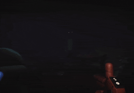 a person is holding a gun in a dark room with a red light coming out of the doorway