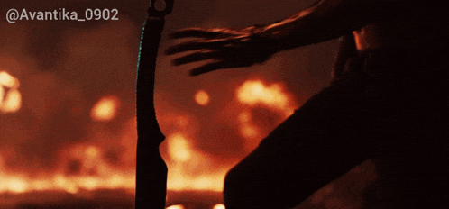 a person holding a knife in front of a fire with the hashtag avantika_0902