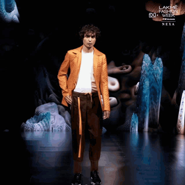 a model walks down a runway at lakme fashion week