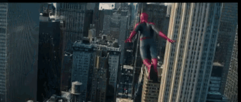 a man in a spiderman costume is flying over a city