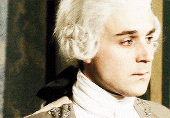 a man with white hair is wearing a white collar