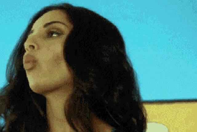 a close up of a woman making a funny face .