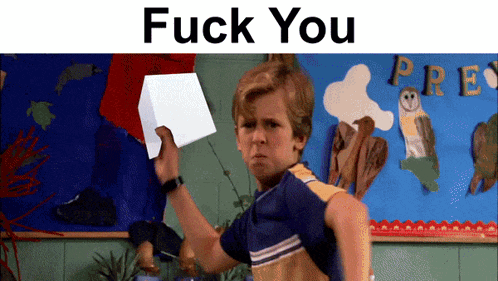 a boy is holding a white cube in front of a bulletin board that says pre