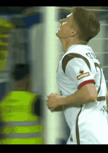 a soccer player wearing a white shirt with the number 2 on it