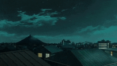a shooting star is flying in the night sky above a city .
