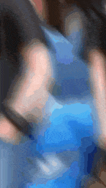 a blurry picture of a person holding a blue bag