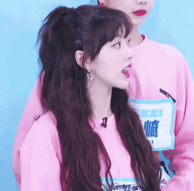 a girl wearing a pink shirt with the number 43 on the front