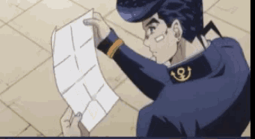 a man in a blue uniform is holding a piece of paper in his hand .