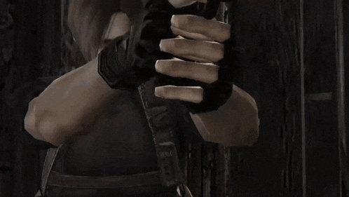 a man is holding a gun with smoke coming out of it .