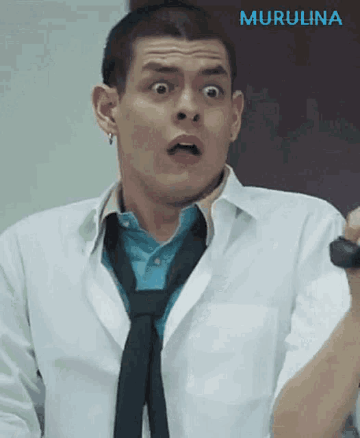 a man wearing a white shirt and a black tie has a surprised expression on his face