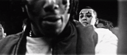 a black and white photo of a group of people standing next to each other .