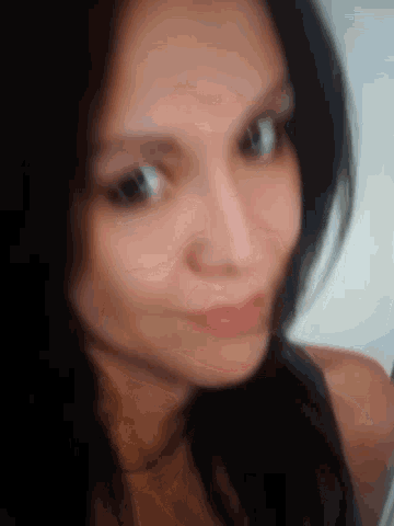 a blurry photo of a woman 's face with her eyes closed