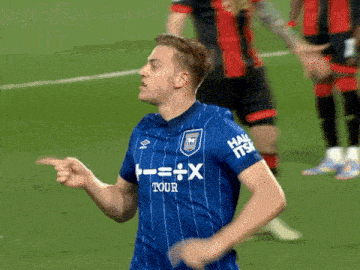 a soccer player wearing a blue shirt that says t = x tour