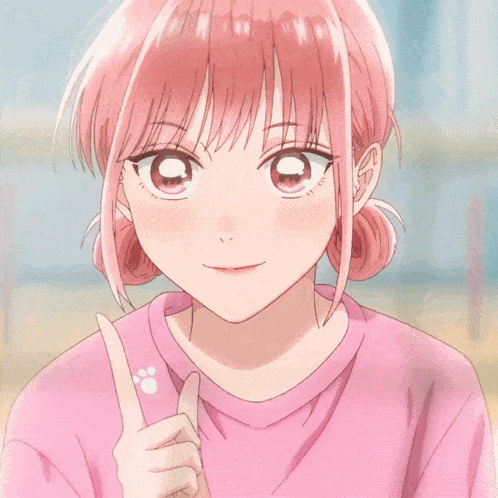 a girl with pink hair is wearing a pink shirt and pointing upwards