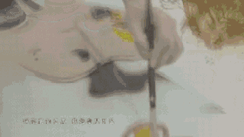 a person is cutting a piece of paper with scissors