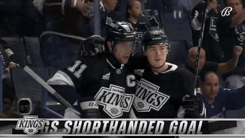 two hockey players from the los angeles kings celebrate their shorthanded goal