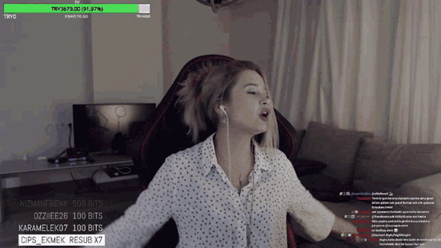a woman in a polka dot shirt is playing a video game on a computer