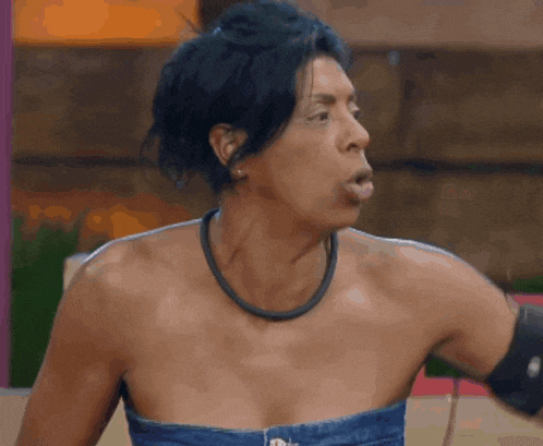 a woman without a shirt is making a face
