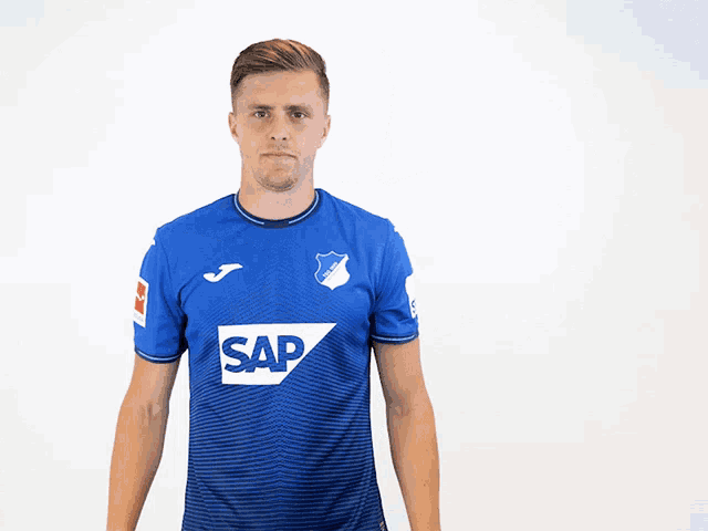 a man wearing a blue jersey with the number 14 on the back