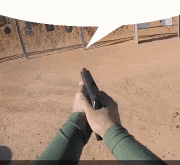 a person is holding a gun with a speech bubble above them