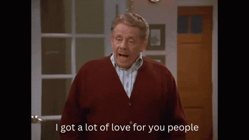 a man in a red cardigan is saying i got a lot of love for you people