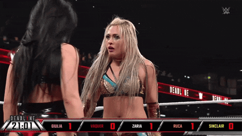 two women in a wrestling ring with a scoreboard that says deadline