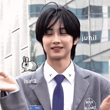 a man in a suit and tie with a pixelated bunny on his jacket and a name tag that says isa 3