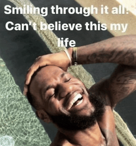 a man with a beard is smiling in a pool with the caption smiling through it all