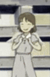 a girl in a white dress is standing in front of a stack of books .